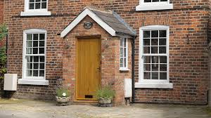 photo of house front with enclosed brick porch